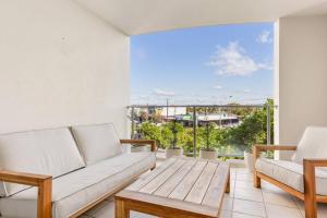 a living room with a couch and a table at Fresh Beautifully Styled 2 BR Resort Apt at Marcoola in Marcoola