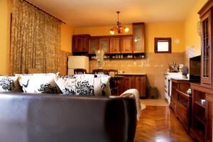 a kitchen and a living room with a couch and a table at Holiday Home Gazevic in Virpazar