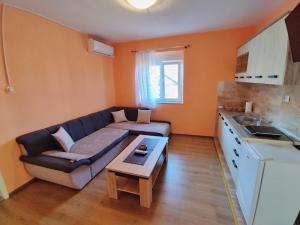 a living room with a couch and a table at Apartman Ss in Trebinje