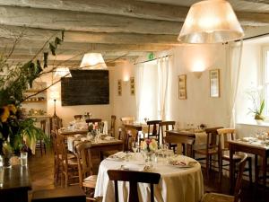 a restaurant with tables and chairs in a room at Hotel La Bougnate in Blesle