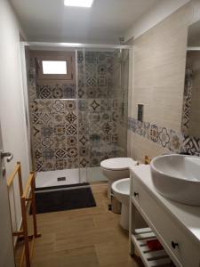 a bathroom with a toilet and a sink and a shower at Vacanze Nella casetta in Pula