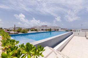 a swimming pool on the roof of a building at Infinito Condos in Playa del Carmen