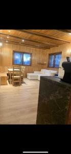 a large room with a couch and a table and chairs at Nouveau - plein centre Valberg - App 6 couchages in Péone +14 photos