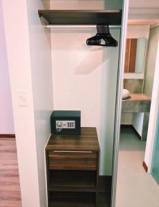 a walk in closet with a clock on a table at Fiori Apartments in Santa Cruz de la Sierra