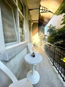 a table and a chair on a balcony at Home in Varna City +19 photos