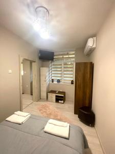 a bedroom with a bed with two towels on it at Home in Varna City