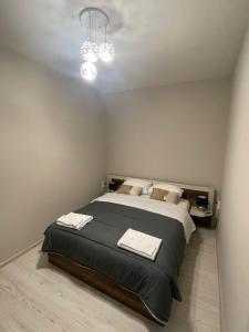 a bedroom with a large bed with towels on it at Home in Varna City