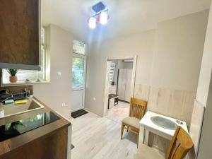 a kitchen with a sink and a table in a room at Home in Varna City +19 photos