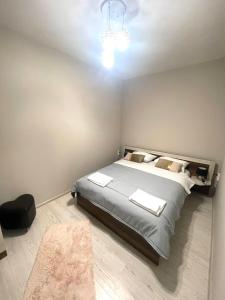 a bedroom with a large bed and a chandelier at Home in Varna City
