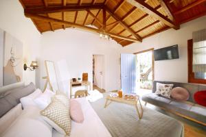 a living room with a couch and a table at Dafnes in Skopelos Town