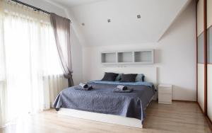 a bedroom with a bed with two towels on it at Ancoba House in Łomna