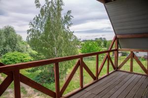 a deck with a view of a tree at Ancoba House in Łomna