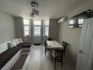 a living room with a bed and a table and chairs at Dream in Varna City