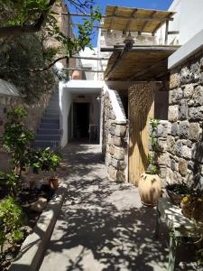 a hallway of a house with a stone wall at Latmos 1860 in Skala