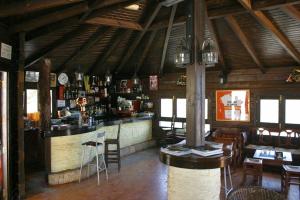 a restaurant with a bar in a wooden building at Hotel VegaSierra in Bogarra