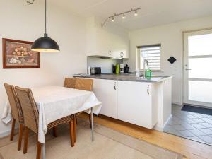 a kitchen and dining room with a table and chairs at Apartment Hals IV in Hals