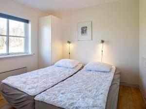 a bedroom with two beds and a window at Apartment Hals IV in Hals