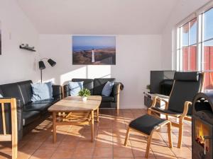 a living room with a couch and a table at Three-Bedroom Holiday home in Hvide Sande 2 in Nørre Lyngvig