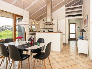 a kitchen and dining room with a table and chairs at 8 person holiday home in Ulfborg in Thorsminde
