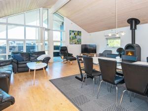a living room with a couch and a table at Four-Bedroom Holiday home in Hemmet 7 in Falen
