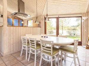 a dining room with a white table and chairs at 8 person holiday home in Fjerritslev in Torup Strand