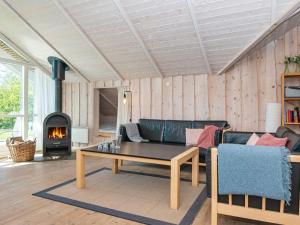 a living room with a couch and a fireplace at 8 person holiday home in Hemmet in Hemmet
