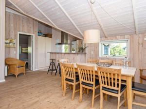 a kitchen and dining room with a table and chairs at 8 person holiday home in Hemmet in Hemmet