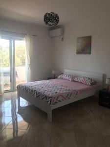 a bedroom with a bed in a room with a window at Suka Apartments in Ulcinj