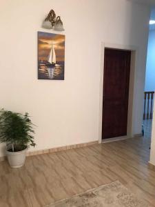 a room with a painting of a sailboat on the wall at Suka Apartments in Ulcinj