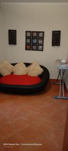 a room with a red and black bed with pillows at Porto marina&spa in El Alamein