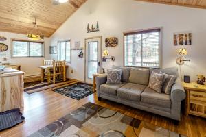 a living room with a couch and a table at A Run Away With Me in Estes Park