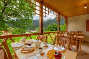 a dining room with a table with food on it at Chiora Inn in Chiora