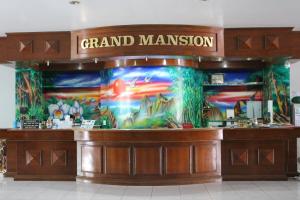a grand miami restaurant with a mural on the wall at Grand Mansion Hotel in Krabi town