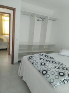 a bedroom with a bed with a pillow on it at Cs9 Casa de 3 quartos a 15 min de Curitiba in Campina Grande do Sul