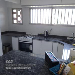 a kitchen with a stove and a counter top at DEPARTAMENTO CASEROS TRES Dormitorios in Salta