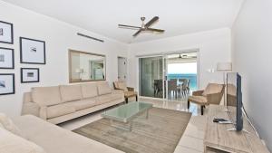 a living room with a couch and a table at Deep Blue Apartment 20 Tangalooma in Tangalooma