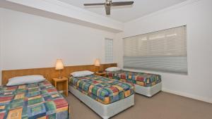 a bedroom with two beds and a window at Deep Blue Apartment 20 Tangalooma in Tangalooma
