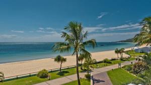 a view of a beach with palm trees and the ocean at Deep Blue Apartment 20 Tangalooma in Tangalooma