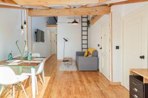 a living room with a table and a couch at Buhardilla de diseño en pleno centro de Santander in Santander