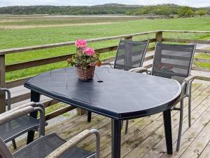 Varekilにある5 person holiday home in VAREKILのデッキの鉢植えの黒いテーブル