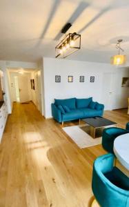 a living room with a blue couch and a table at Brand New Luxury 3 bedrooms, Terrace and Free Parking - noah in Luxembourg