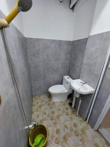 a bathroom with a toilet and a sink at MANIPON TRANSIENT HOUSE in San Juan