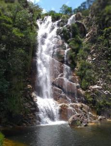 a waterfall in the middle of a river at Famiglia da Serra in Delfinópolis