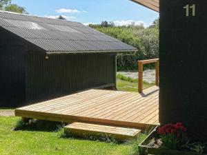 a wooden deck on the side of a house at 5 person holiday home in Fur in Fur
