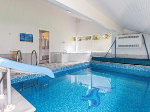 a swimming pool with a slide in a bathroom at 12 person holiday home in Saltum in Saltum