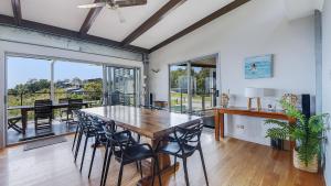 a dining room with a table and chairs at Ohana Beach House in Tangalooma