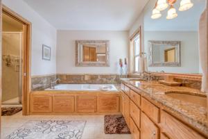 a bathroom with a tub and two sinks and a shower at Mugho 10 - Meredith Lodging in Sunriver +56 photos