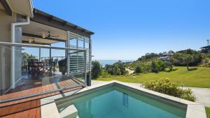 a house with a swimming pool and a patio at Ohana Beach House in Tangalooma