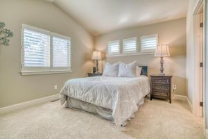 a bedroom with a bed and two windows at East Bend Beauty in Bend