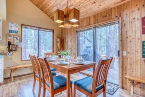 a dining room with a wooden table and chairs at Owls Nest - Meredith Lodging in Sunriver